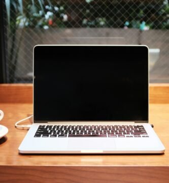 laptop computer beside coffee mug